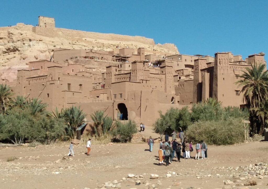 Ait Ben Haddou kasbah palm tourists, Morocco
