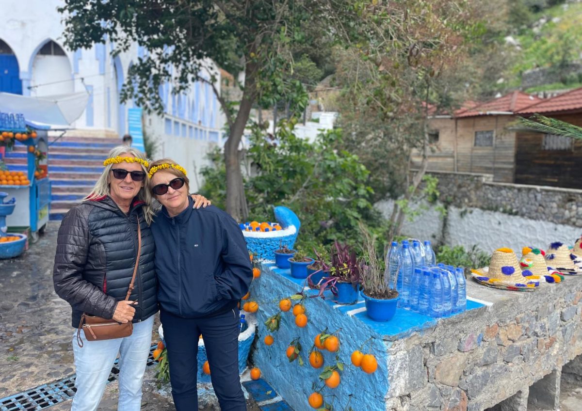 Chefchaouen Orange Juice Stand Couple — Morocco Epic Journey guided Morocco tours across the Sahara desert, kasbahs and imperial cities.
