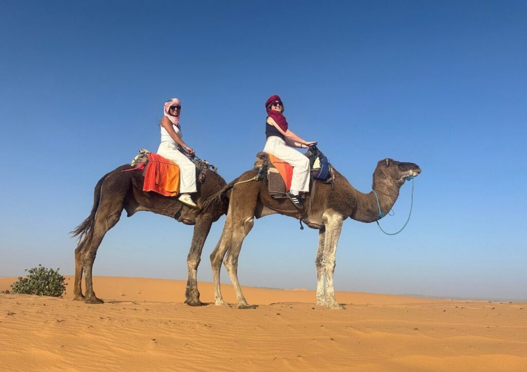 Couple camel ride desert Merzouga, Morocco