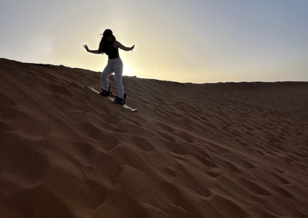 Sandboarding dune sunset Sahara, Morocco